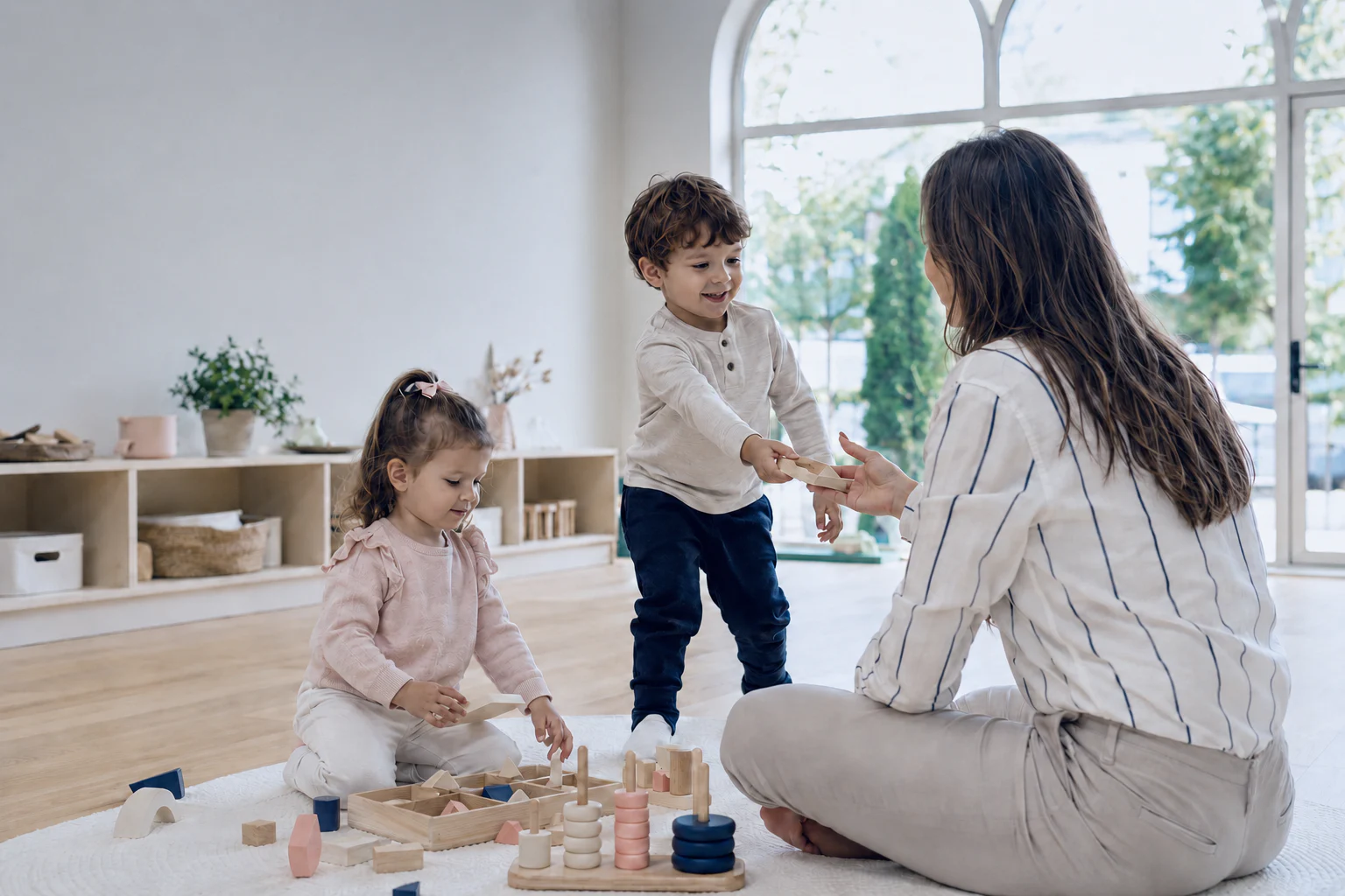 ABA professional guiding two young children through a play-based learning activity